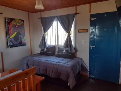 a bedroom with two beds and a window at Portal del Sol in Villa Yacanto