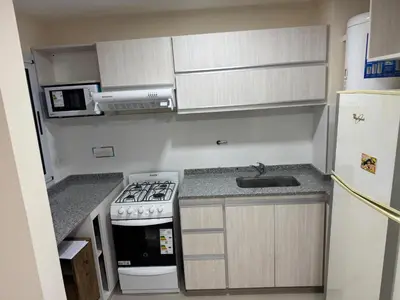 a small kitchen with a stove and a sink at Hermoso Departamento en muy bonita zona de Alta Córdoba, nuevo a estrenar in Cordoba