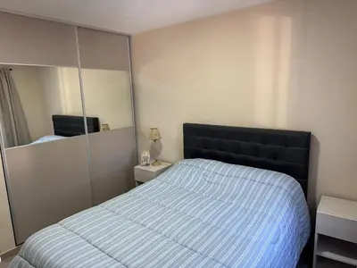 a bedroom with a bed and a large mirror at Hermoso Departamento en muy bonita zona de Alta Córdoba, nuevo a estrenar in Cordoba
