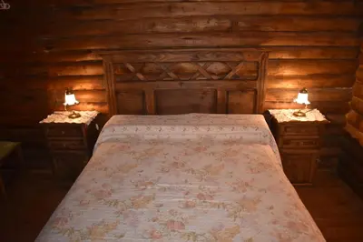 a bedroom with a large bed and two night stands at Cabaña Malibu in Los Reartes