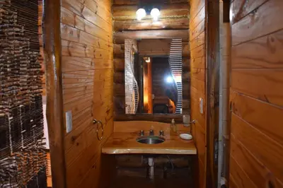 a bathroom with a sink and a mirror at Cabaña Malibu in Los Reartes