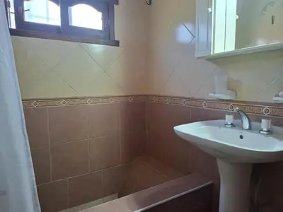 a bathroom with a sink and a shower at Casa con pileta de uso exclusivo in Tanti