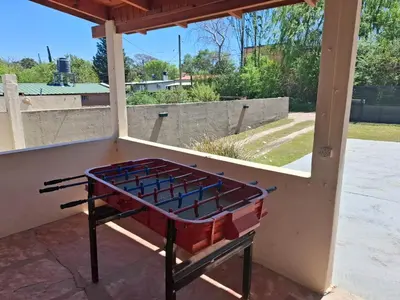 a barbecue grill sitting on a screened porch at Casa con pileta de uso exclusivo in Tanti