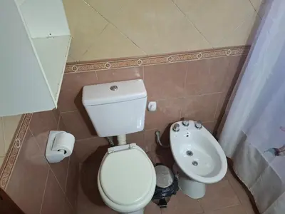 a small bathroom with a toilet and a sink at Casa con pileta de uso exclusivo in Tanti