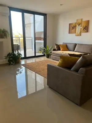 a living room with a couch and a table at CALASANz PREMIUM in Cordoba