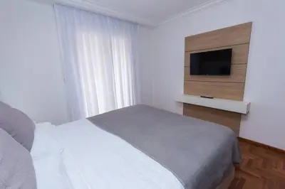 a bedroom with a bed and a flat screen tv at Departamento en Nueva Córdoba in Cordoba
