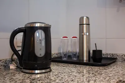 a black appliance sitting on a kitchen counter with glasses at Departamento en Nueva Córdoba in Cordoba