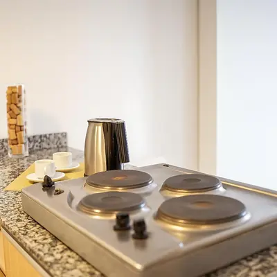 a stove top with a blender on a kitchen counter at Coral State Premium Tower in Cordoba