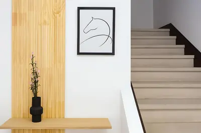 a staircase with a picture of a horse on the wall at Atenea Residence in Cordoba