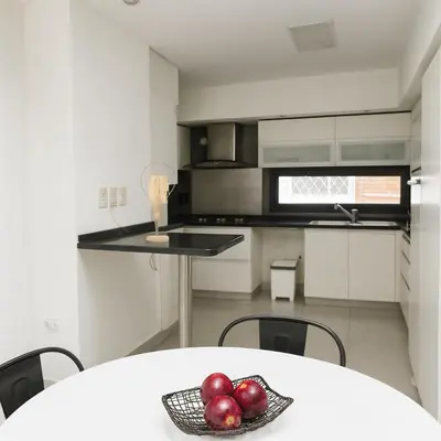 a kitchen with a white table with fruit on it at Atenea Residence in Cordoba