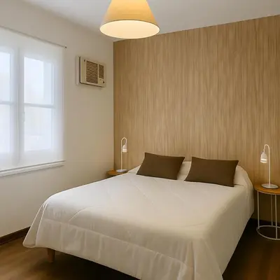 a bedroom with a large white bed and a window at Atenea Residence in Cordoba