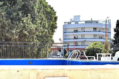a swimming pool in front of a building at Gran hotel argentino in Villa Carlos Paz