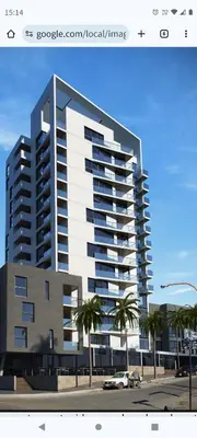 a rendering of a large apartment building with palm trees at Lake in Villa Carlos Paz