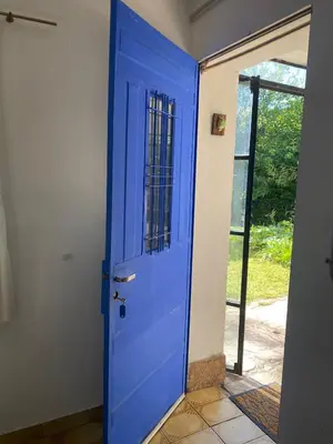 a blue door in a room with an open doorway at La casita azul, Tanti in Tanti