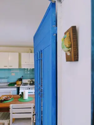 a blue door leading into a kitchen with a table at La casita azul, Tanti in Tanti