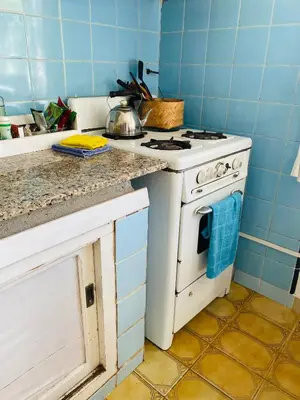 a kitchen with a stove and a counter top at La casita azul, Tanti in Tanti