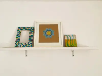 a shelf with a picture and other items on it at La casita azul, Tanti in Tanti