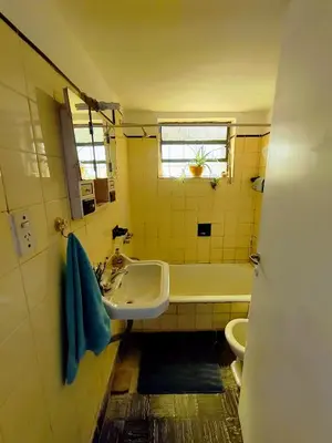 a bathroom with a sink and a tub and a toilet at La casita azul, Tanti in Tanti