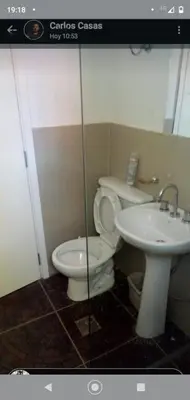 a bathroom with a toilet and a sink at Cabañas La Mimi in Villa Anizacate