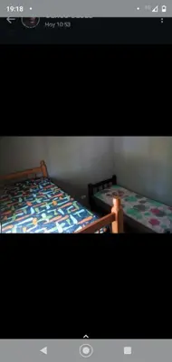 two beds sitting next to each other in a room at Cabañas La Mimi in Villa Anizacate