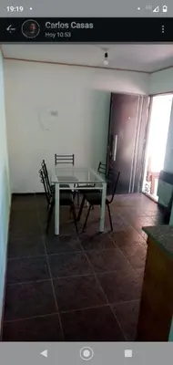 a dining room with a glass table and two chairs at Cabañas La Mimi in Villa Anizacate