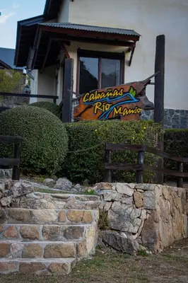 a sign for a restaurant in front of a building at Cabañas Rio Manso in La Cumbrecita