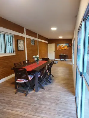 a dining room with a table and chairs at Casa en Villa Amancay, Calamuchita in Villa Amancay