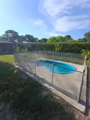 a swimming pool with a fence around it at Casa en Villa Amancay, Calamuchita in Villa Amancay