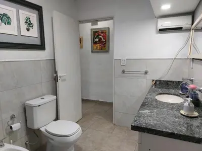 a bathroom with a toilet and a sink at Casa en Villa Amancay, Calamuchita in Villa Amancay