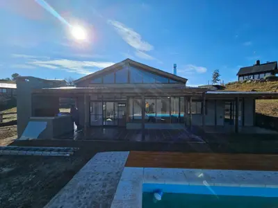a rendering of a house with glass windows at Gran Cabaña Dos Yacanto in Villa Yacanto