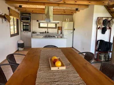 a wooden table with oranges on it in a kitchen at Gran Cabaña Dos Yacanto in Villa Yacanto