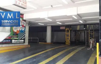 an empty parking garage with a sign on the wall at Departamento Centrico Cordoba in Cordoba