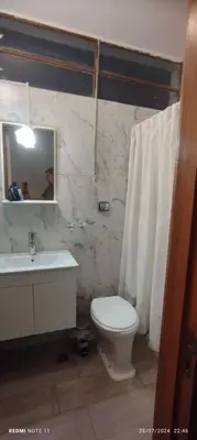 a bathroom with a toilet and a sink and a mirror at Departamento Centrico Cordoba in Cordoba