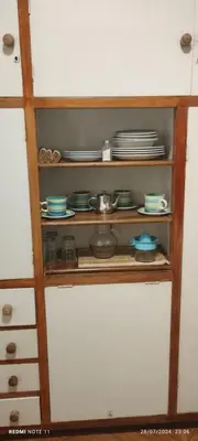 a cabinet with plates and dishes on it at Departamento Centrico Cordoba in Cordoba