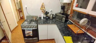 a kitchen with a stove and a counter top at Departamento Centrico Cordoba in Cordoba