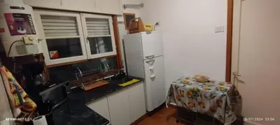 a kitchen with a refrigerator and a table in it at Departamento Centrico Cordoba in Cordoba