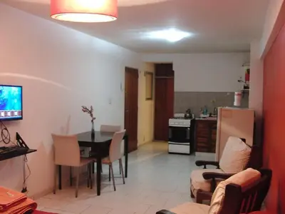 a kitchen and living room with a table and chairs at Departamento Amoblado en Nueva Cordoba in Cordoba
