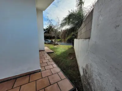 a brick walkway next to a concrete wall at Casa Tío Luis in Villa Carlos Paz