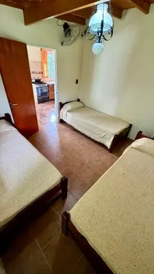 a room with three beds in a room with a ceiling at Cabañas Maranatha in El Rincón