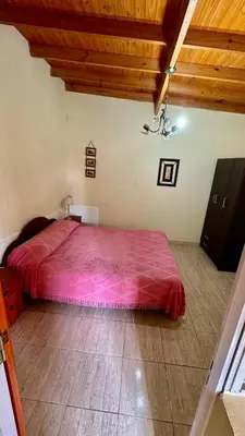 a bedroom with a large bed with a red blanket at Cabañas Maranatha in El Rincón
