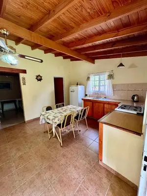a kitchen with a table and chairs in a room at Cabañas Maranatha in El Rincón