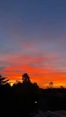 a sunset with trees and a sky at Cabañas Maranatha in El Rincón