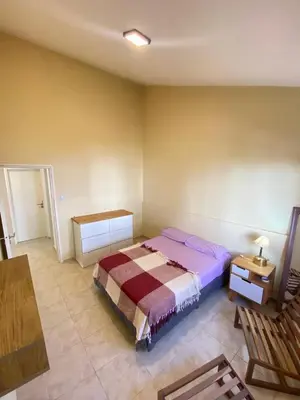 a bedroom with a bed in the corner of a room at Departamento PARQUE Velez Sarsfield, zona sur - Cordoba capital in Cordoba