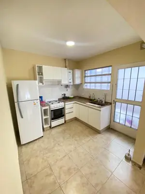 a kitchen with a white refrigerator and appliances at Departamento PARQUE Velez Sarsfield, zona sur - Cordoba capital in Cordoba