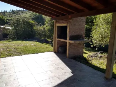 a patio with a brick oven in a yard at Estancia La Victoria - Cabañas de Montaña in Villa Yacanto