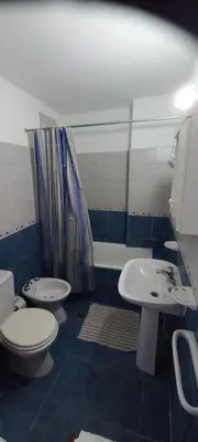 a bathroom with a toilet and a sink and a shower at Cómodo Dpto Colón 600 in Río Cuarto