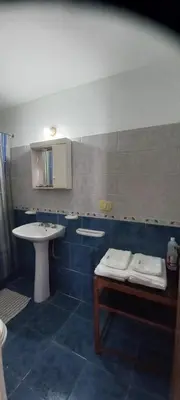 a bathroom with a sink and a toilet and a sink at Cómodo Dpto Colón 600 in Río Cuarto
