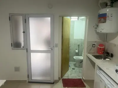a bathroom with a door leading to a toilet at studios in Cordoba in Cordoba