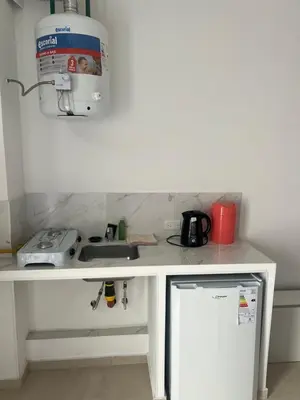a kitchen counter with a sink and a microwave at studios in Cordoba in Cordoba