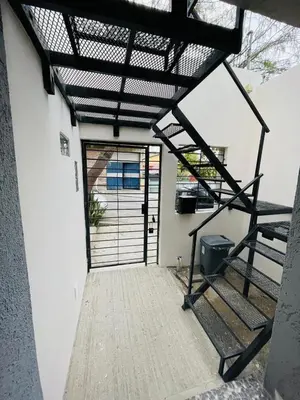 an open door of a house with a metal gate at studios in Cordoba in Cordoba
